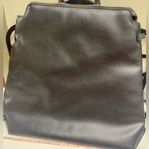 Brand new- never used soft black backpack with carrying handle.